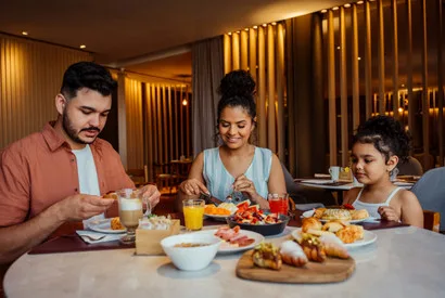 Family sharing a nutritious meal with fresh vegetables, proteins, and wholesome ingredients at home dining table.