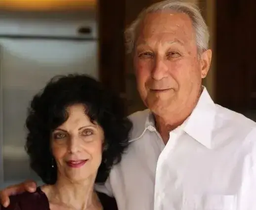 Elder couple enjoying a warm moment in a cozy kitchen, radiating love and connection.